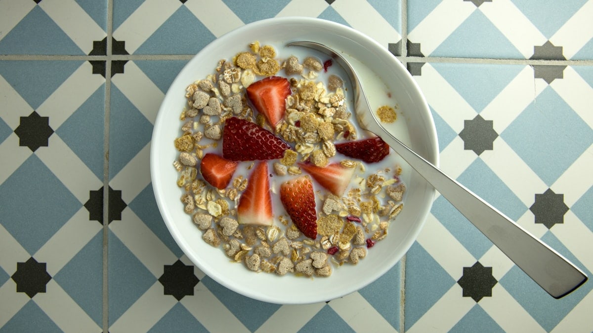 a bowl of granola with strawberries and yogurt